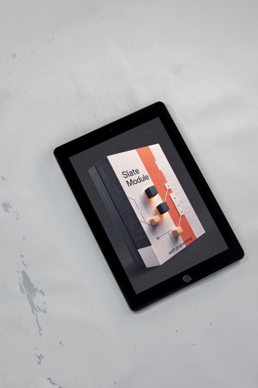 A black tablet device lying on a light gray textured surface, displaying a book or magazine cover titled "Slate Module" on its screen.